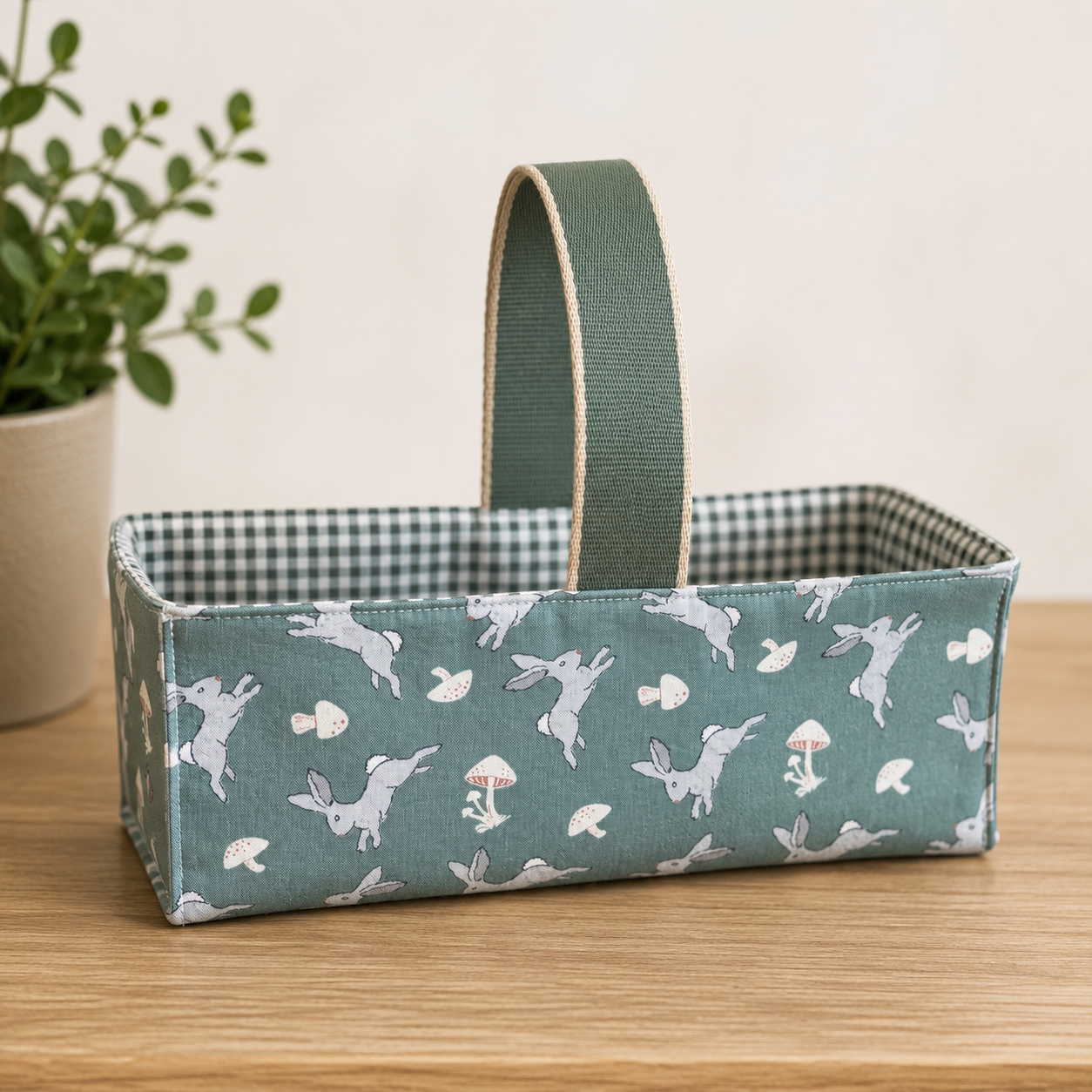 Handmade fabric basket in sage green bunny and mushroom print with sage gingham lining and grosgrain handle