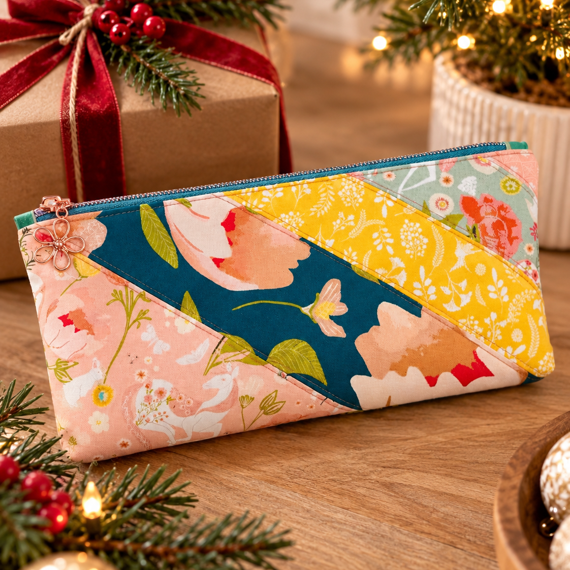 Sunset zipper pouch in peach, teal and yellow florals with pine and red berries