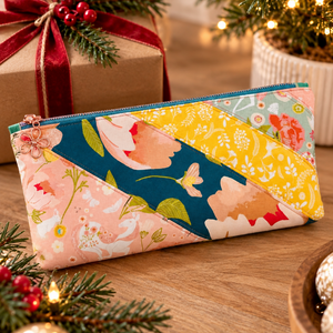 Sunset zipper pouch in peach, teal and yellow florals with pine and red berries