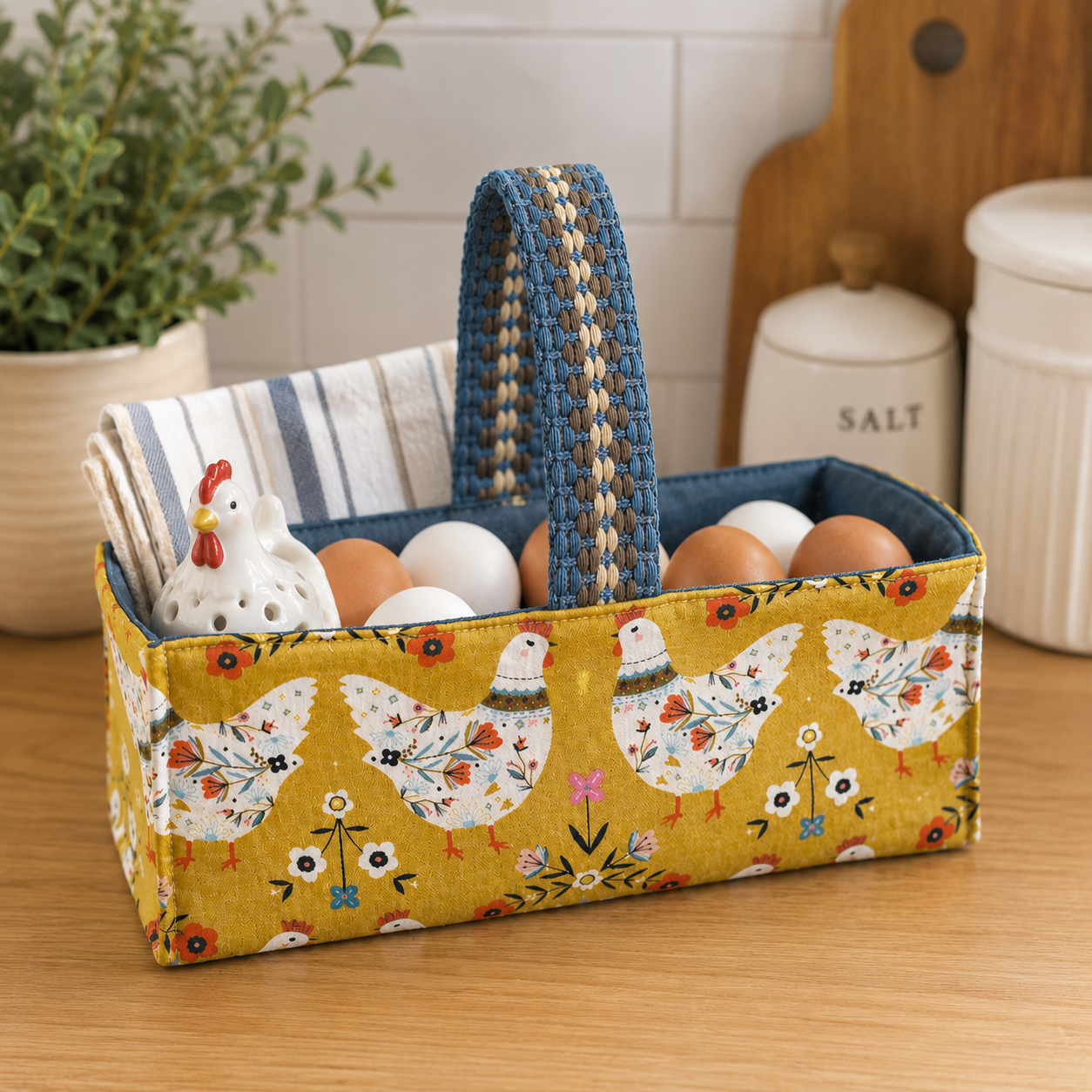 Handmade fabric basket in golden mustard folk art hen print with denim blue lining and woven handle