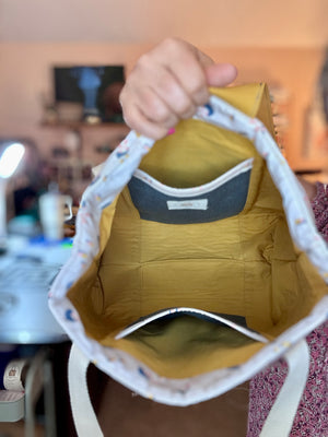 Lakeside Tote side view showing cream webbing handles and structure