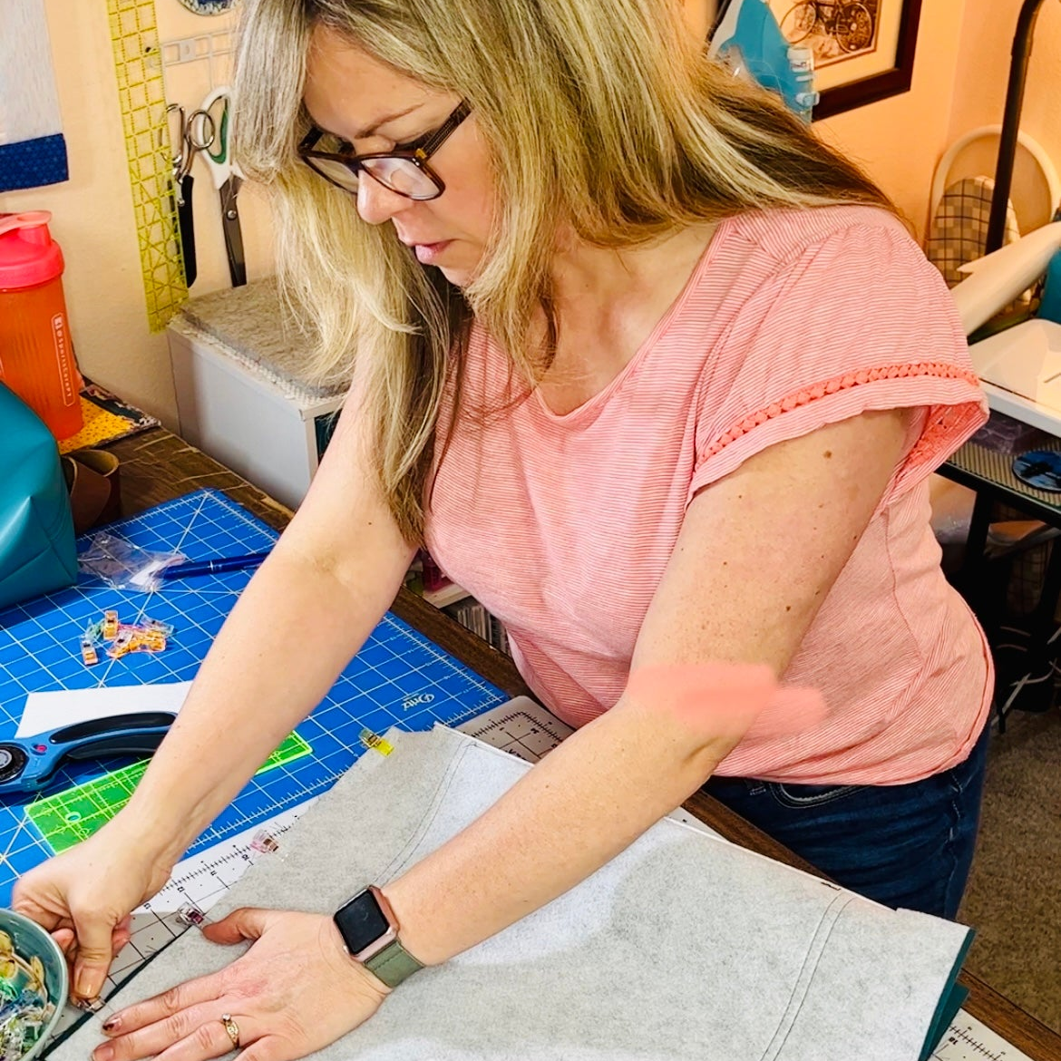 Woman working on a craft project in a home workshop.