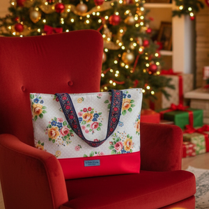 Floral Joanna Tote on a red armchair by a Christmas tree