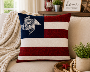 Decorative pillow with American flag design on a couch in a cozy living room.