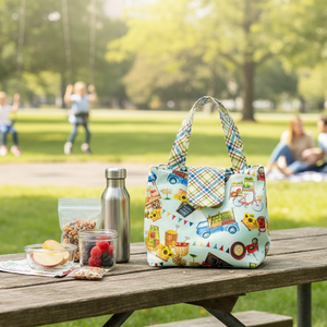 Colorful patterned bag on a wooden picnic table with a park background