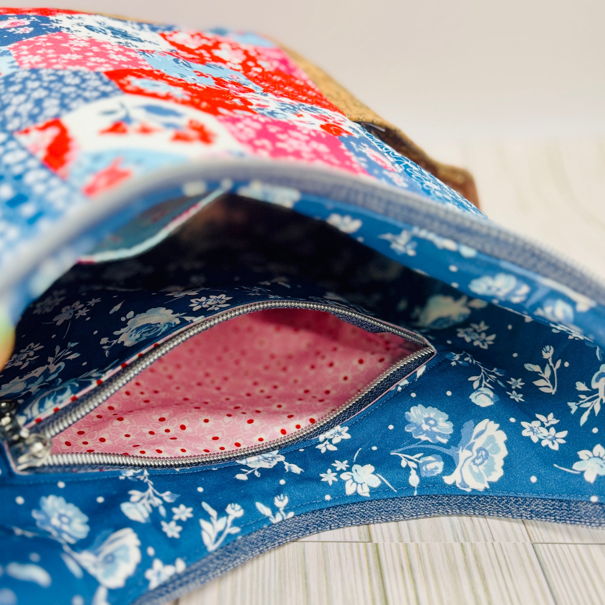 Interior view of patchwork elise handbag for summer showing zipper pocket and floral lining